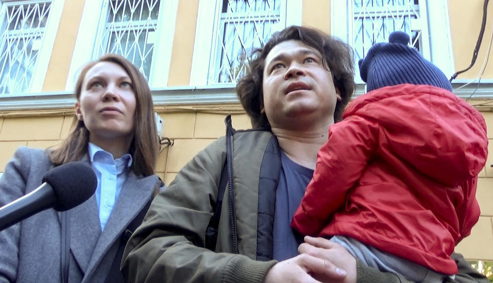 This video grab provided by TV Rain on Tuesday, Aug. 6, 2019, shows Dmitri and Olga Prokazov, parents of a 1-year-old boy speaking to journalists in Moscow, Russia . Moscow's children's rights ombudsman and other public figures have reacted with outrage to Russian prosecutors' moves to remove a 1-year-old boy from his parents because they allegedly took him to an unauthorized protest. (TV RAIN via AP) RUSSIA OUT