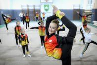 Sara Becarevic performs a gymnastics routine in Visoko, Bosnia, Wednesday, Dec. 1, 2021. In Bosnia, a poor, Balkan country which habitually marginalizes people with disabilities, a soon-to-be-14-year-old girl, born without her lower left arm, pursues her dream of becoming an internationally recognized rhythmic gymnast. Sara Becarevic says she got enchanted with the demanding sport as a toddler, while watching the world championships on television. (AP Photo)