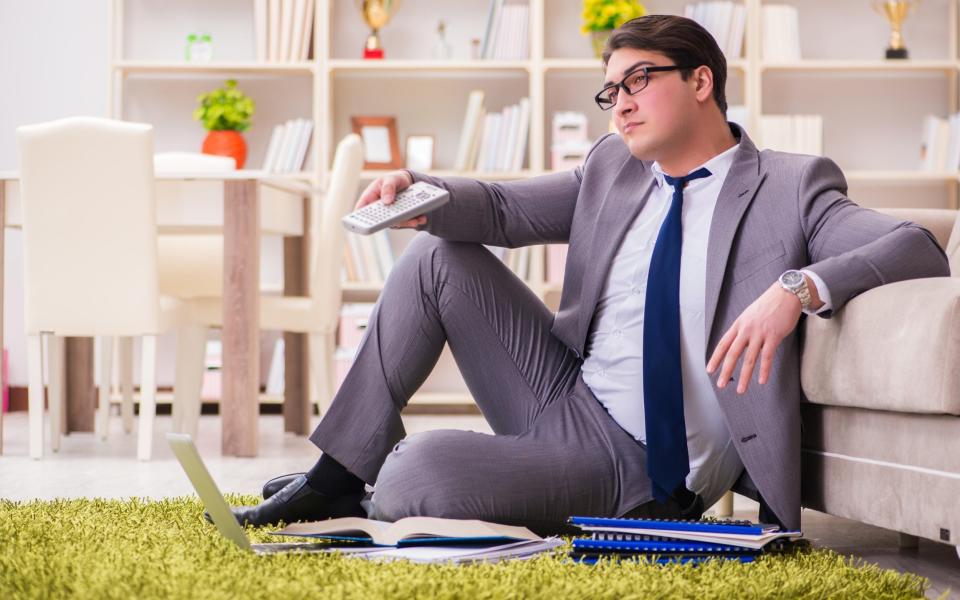 Businessman working on the floor at home