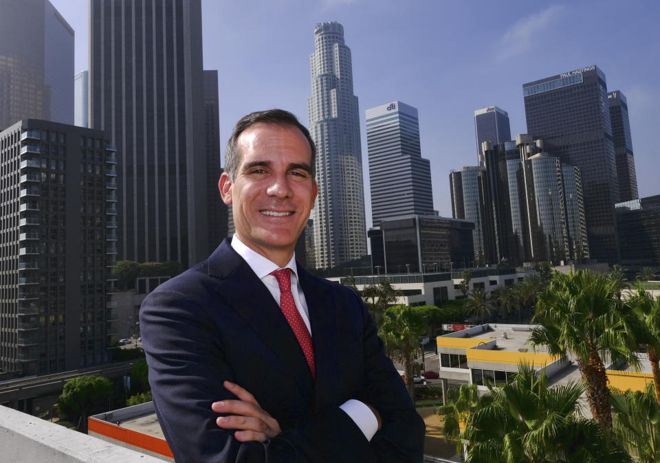 FILE - In this Aug. 23, 2018, file photo Los Angeles Mayor Eric Garcetti poses for a photo in front of a sprawling downtown Los Angeles landscape. Former Vice President Joe Biden and several nationally known senators are commanding most of the attention in Democrats’ early presidential angling, but there are several governors and mayors, including Garcetti, eyeing 2020 campaigns, as well.(AP Photo/Richard Vogel, File)