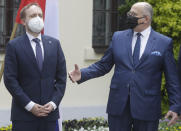 Poland's Foreign Minister Zbigniew Rau,right,, gestures toward Czech Minister Jakub Kulhanek, ahead of a meeting with regional counterparts in Lodz, Poland, Friday, May 14, 2021.(AP Photo/Czarek Sokolowski)