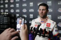 Denny Hamlin answers questions form members of the media during NASCAR Daytona 500 auto racing media day at Daytona International Speedway, Wednesday, Feb. 12, 2020, in Daytona Beach, Fla. (AP Photo/John Raoux)