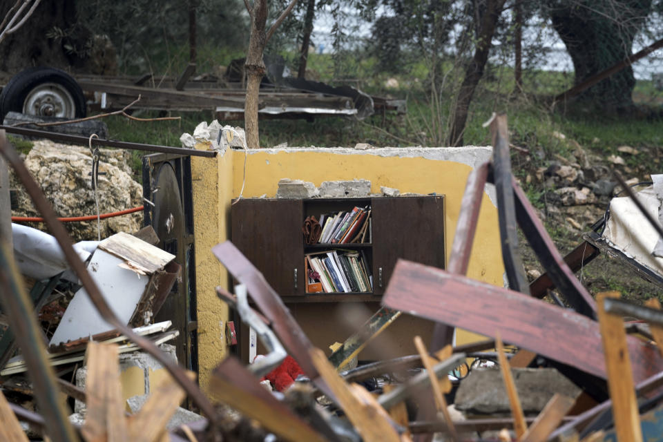 A book shelf is seen at the ruins of a Palestinian house demolished by the Jerusalem municipality in the flashpoint east Jerusalem neighborhood of Sheikh Jarrah, Wednesday, Jan. 19, 2022. Israeli police on Wednesday evicted Palestinian residents from the disputed property and demolished the building, days after a tense standoff. The family says it has lived on the property since before 1967, while the city says they are squatters. It plans to build a special needs school at the site and says it will compensate the property's owners. (AP Photo/Mahmoud Illean)