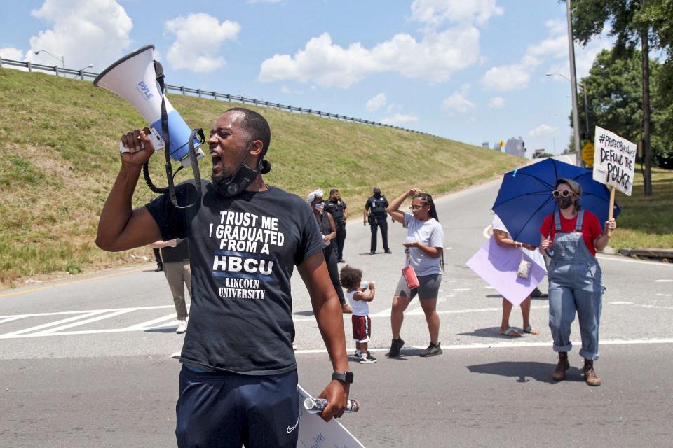 Protestors block University Avenue and the onramp to I-75 northbound near the Wendy's fast food restaurant in Atlanta on Saturday,  June 13, 2020, where Rayshard Brooks, a 27-year-old Black man, was shot by Atlanta police Friday evening during a struggle in a drive-thru line.
