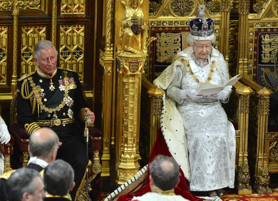 Britain's Queen Elizabeth delivers her speech during the State Opening of Parliament at the House of Lords, alongside Prince Charles in London Wednesday May 8, 2013. The State Opening of Parliament marks the formal start of the parliamentary year, the Queen delivered a speech which set out the government's agenda for the coming year. (AP Photo/Toby Melville, Pool)