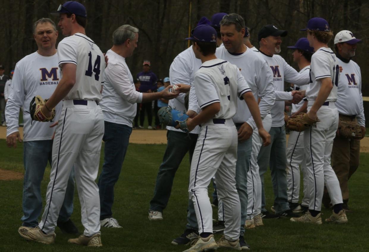 The Marshwood High School 1984 state championship baseball team throwing out ceremonial first pitch with current Hawks players prior to Saturday's game against Noble at Marshwood High School.