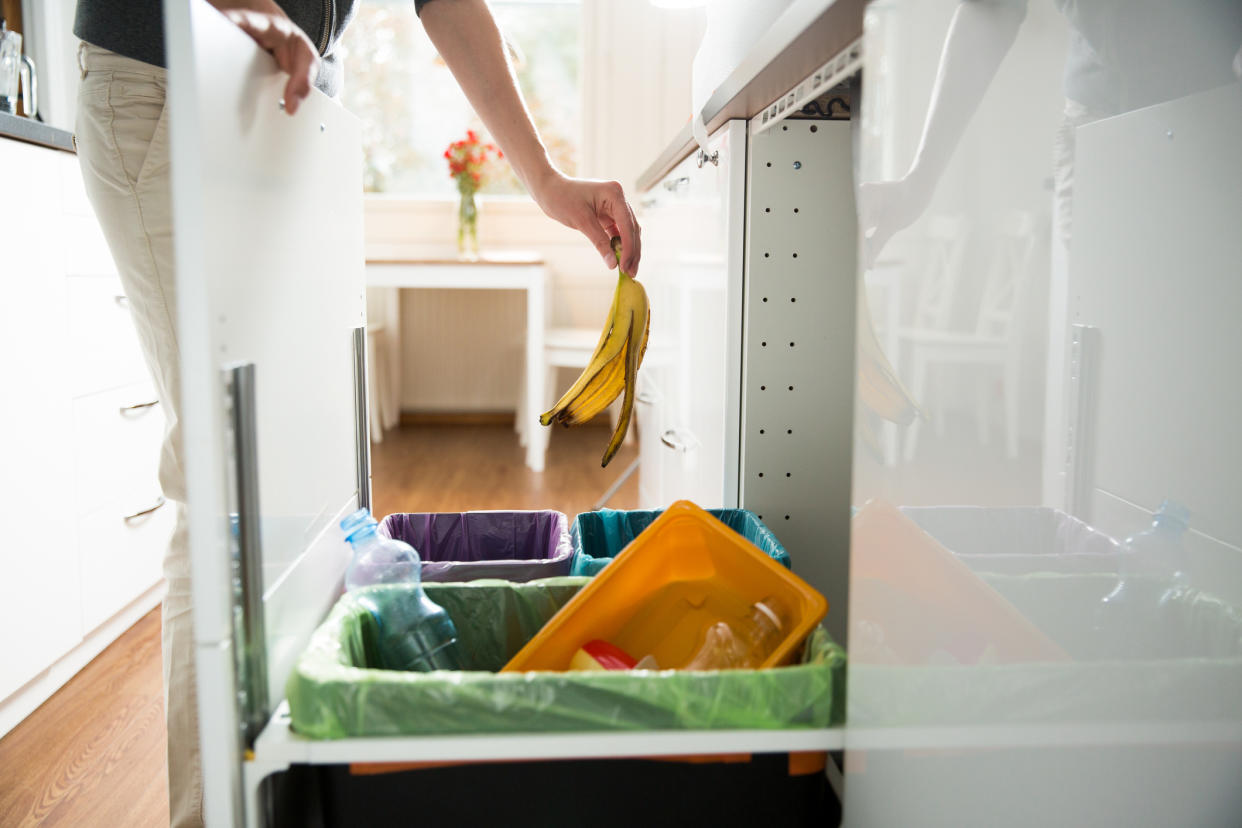 Stock picture of a woman throwing something into the recycling bin. (Getty Images)