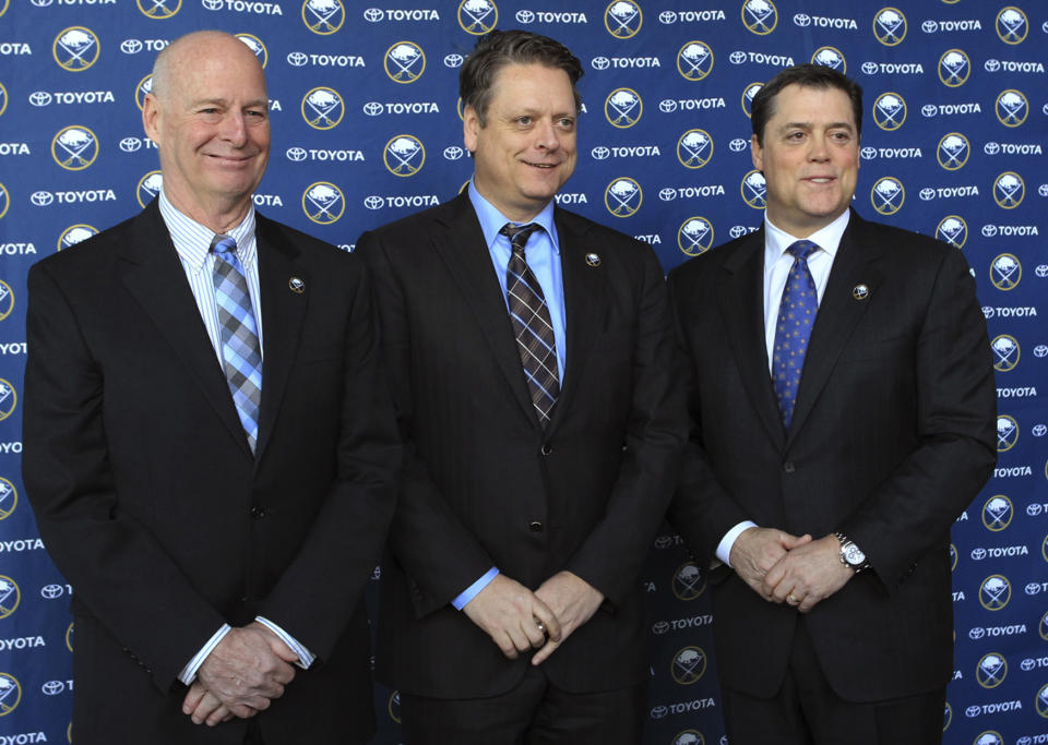 Craig Patrick, left, Tim Murray, center, and Pat LaFontaine pose for a photo after a news conference naming Murray as general manager of the Buffalo Sabres NHL hockey team and Patrick as special assistant and adviser to the hockey department, Thursday, Jan. 9, 2014, in Buffalo N.Y. LaFontaine is president of the team. (AP Photo/Nick LoVerde)