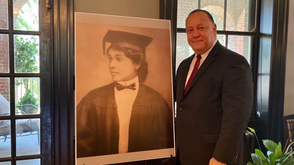 During the reception in Hulda Lyttle Hall Parlor, David Wells Given, a descendant of Dr. Josephine English Wells, poses next to a portrait of his ancestor.