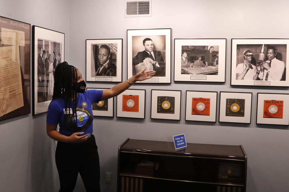 Motown Museum tour guide Jamia Henry points out notable Motown legends during a tour of the museum, Wednesday, July 15, 2020, in Detroit. The Detroit building where Berry Gordy Jr. built his music empire reopened its doors to the public on Wednesday. It had been closed since March due to the coronavirus pandemic. (AP Photo/Carlos Osorio)