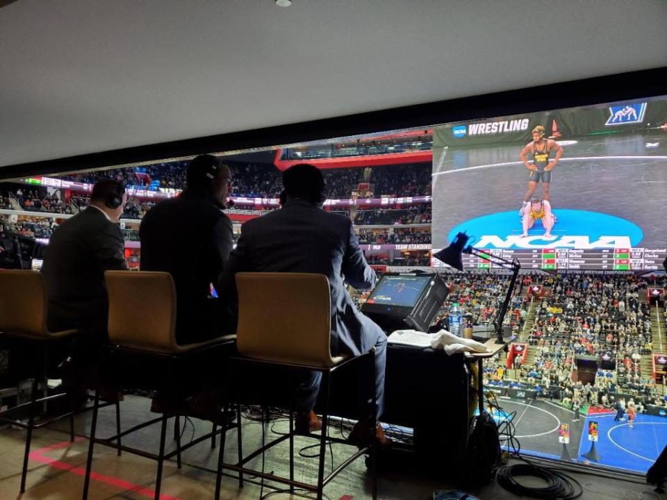 Shawn Kenney, left, announced the 2022 NCAA Championships. He is pictured here with analysts J'den Cox, center, and Rock Harrison, right, inside Little Caesars Arena in Detroit, Mich.