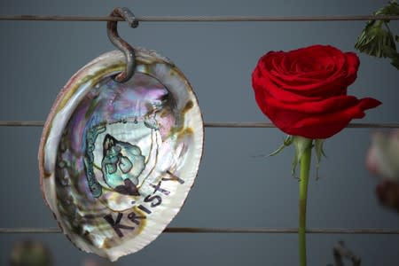 A name is written on a shell as it hangs on a makeshift memorial near Truth Aquatics as the search continues for those missing in a pre-dawn fire that sank a commercial diving boat near Santa Barbara, California