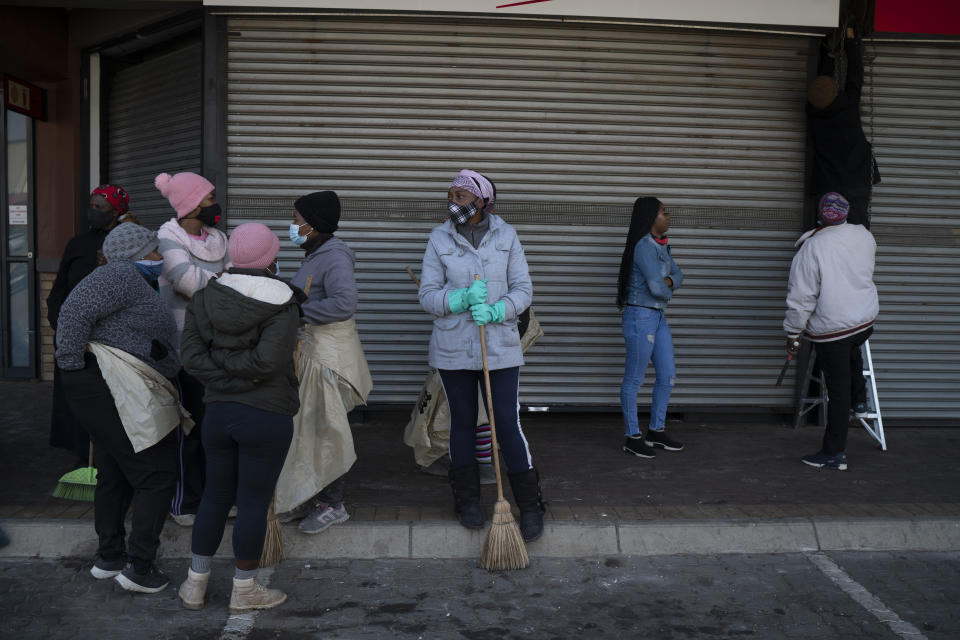 Volunteers participate in the cleaning efforts at Soweto's Diepkloof mall outside Johannesburg, South Africa, Thursday July 15, 2021. A massive cleaning effort has started following days of violence in Gauteng and KwaZulu-Natal provinces. A massive cleaning effort has started following days of violence in Gauteng and KwaZulu-Natal provinces. The violence erupted last week after Zuma began serving a 15-month sentence for contempt of court for refusing to comply with a court order to testify at a state-backed inquiry investigating allegations of corruption while he was president from 2009 to 2018. (AP Photo/Jerome Delay)