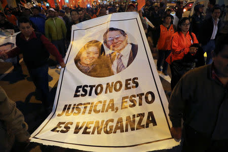 Supporters of Keiko Fujimori, daughter of former president Alberto Fujimori and leader of the opposition in Peru, protest against her detention in Lima, Peru October 15, 2018. The banner reads: "This is no justice, this is revenge". REUTERS/Guadalupe Pardo