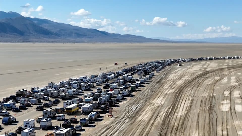 A caravan of vehicles lined up to leave the Burning Man festival near Black Rock City, Nevada, on September 4, 2023. - CNN