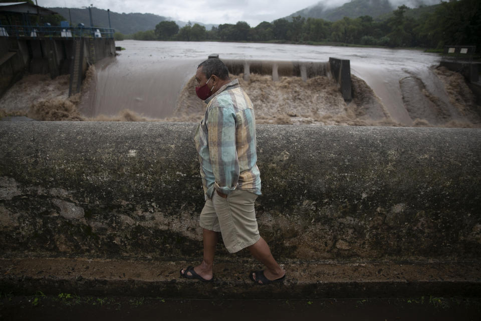 Un hombre camina por un puente sobre el río Los Esclavos tras las lluvias asociadas a la tormenta tropical Amanda, en Cuilapa, Guatemala, el domingo 31 de mayo de 2020. (Foto AP/Moisés Castillo)