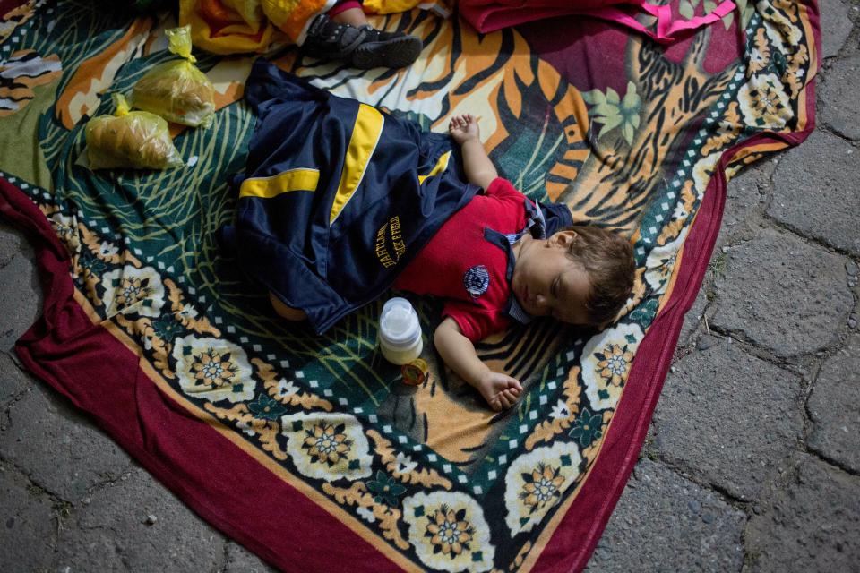 A Honduran migrant sleeps on the street outside a shelter in Esquipulas, Guatemala, Wednesday, Jan. 16, 2019. The latest caravan of Honduran migrants hoping to reach the U.S. has crossed peacefully into Guatemala, under the watchful eyes of about 200 Guatemalan police and soldiers.