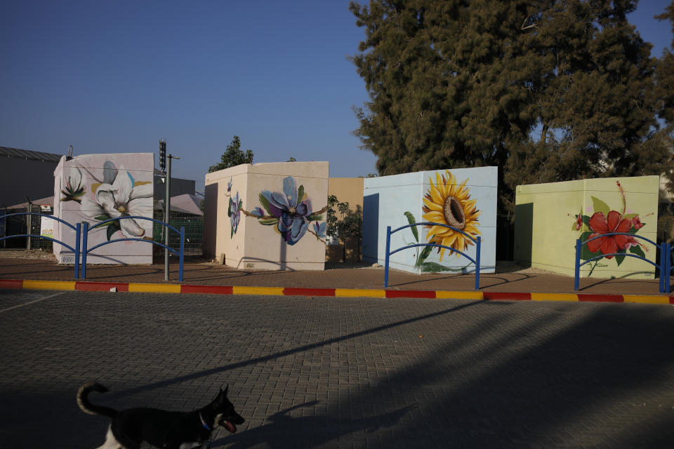 Small concrete bomb shelters painted in bright colors for children waiting for their school bus, in Sderot, Israel, July 28, 2021. No place in Israel has been hit harder by Palestinian rocket fire than Sderot, a working-class town just about a mile (1.5 kilometers) from the Gaza border. Although Sderot is enjoying an economic boom and revival, a generation of children and parents are suffering from the traumatic effects of two decades of rocket fire that experts are still struggling to understand. (AP Photo/Ariel Schalit)