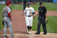 Pittsburgh Pirates' Jack Suwinski (65) scores between umpire Lance Barrett, right, and Cincinnati Reds catcher Tyler Stephenson on a balk by Reds p;itcher Luis Castillo during the second inning of a baseball game in Pittsburgh, Saturday, May 14, 2022. (AP Photo/Gene J. Puskar)