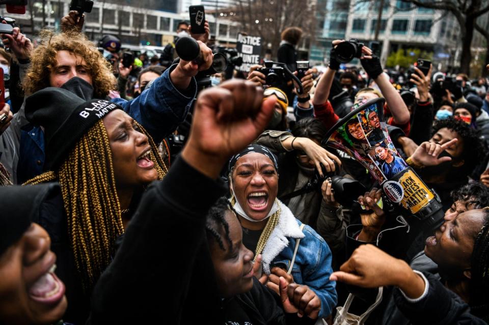 People celebrate as the verdict is announced in the trial of former police officer Derek Chauvin outside the Hennepin County Government Center in Minneapolis, Minnesota (AFP via Getty Images)