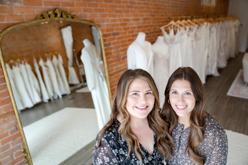 Bri Buzick, left, and Mallory Gritsch stand for a photo at Holland Bridal Shoppe, their new bridal shop in Pella.