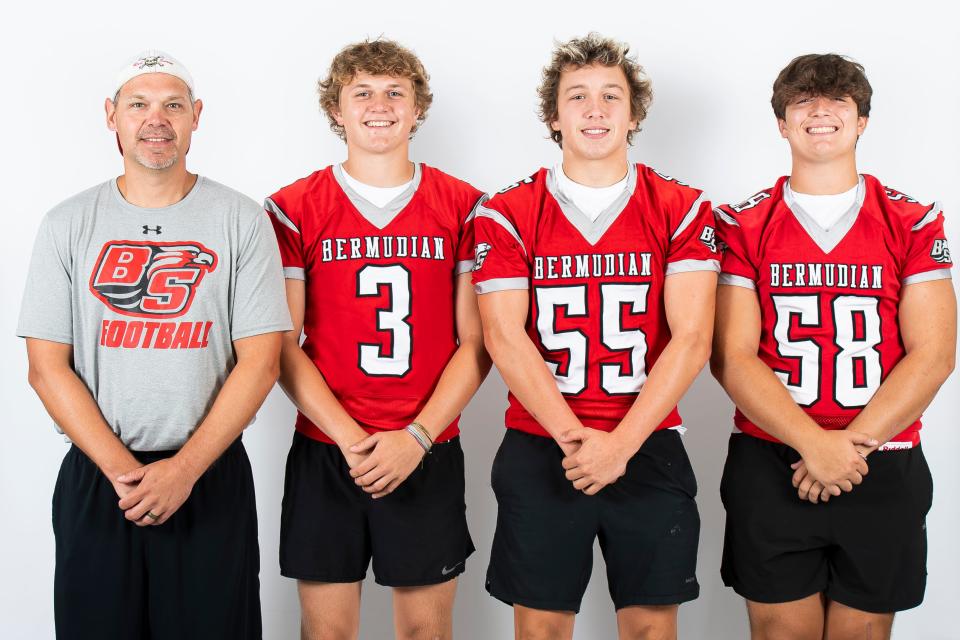 Bermudian Springs football players Tyson Carpenter (3), Brodie Smith (55) and Kayden King (58) pose for a photo with head coach John Livelsberger during YAIAA football media day on Tuesday, August 1, 2023, in York.