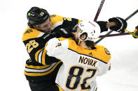 Boston Bruins defenseman Brandon Carlo (25) collides with Nashville Predators center Tommy Novak (82) during the first period of an NHL hockey game Tuesday, March 28, 2023, in Boston. (AP Photo/Charles Krupa)