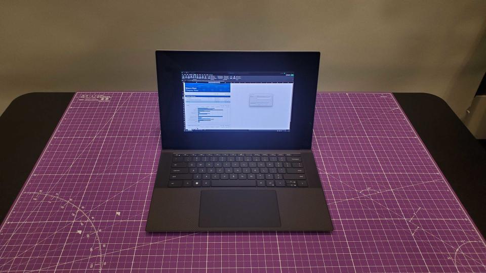 silver laptop sitting on purple desk