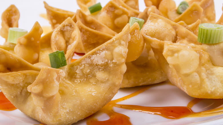Close-up of crab rangoon on white plate