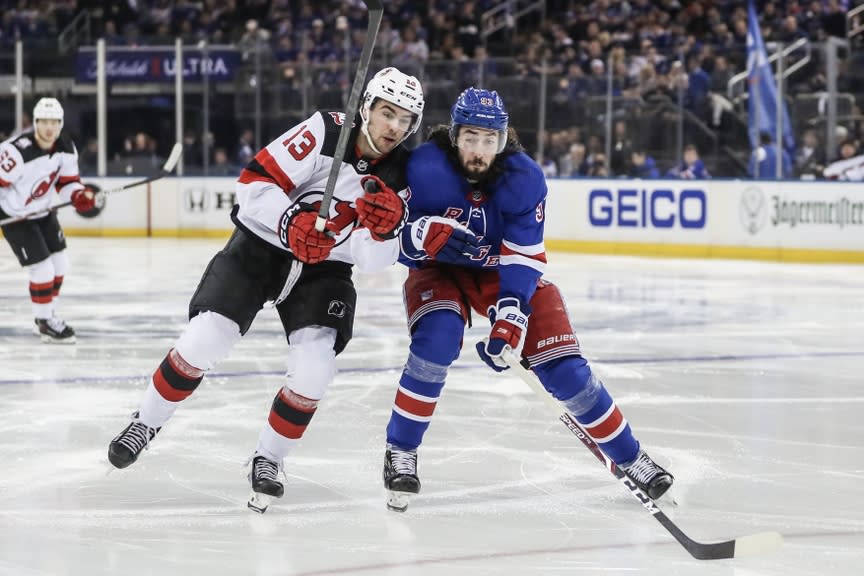 New Jersey Devils center Nico Hischier (13) and New York Rangers center Mika Zibanejad (93) battle for control of the puck in game three of the first round of the 2023 Stanley Cup Playoffs at Madison Square Garden.