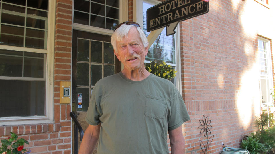 In this Wednesday, July 31, 2019 photo Arlie Ward, owner of a hotel, discusses the impact of the closure of the nearby Pend Oreille Mine in downtown Metaline Falls, Wash. The mine closure will cost 200 good-paying jobs in the rural area. (AP Photo/Nicholas K. Geranios)