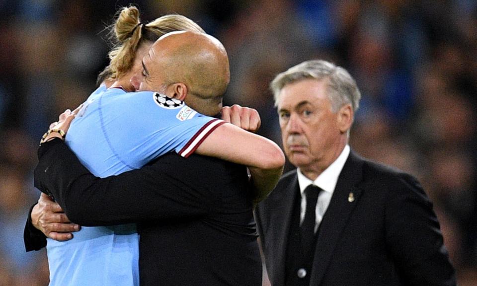 <span>Carlo Ancelotti looks on as Pep Guardiola and <a class="link " href="https://sports.yahoo.com/soccer/players/1734953/" data-i13n="sec:content-canvas;subsec:anchor_text;elm:context_link" data-ylk="slk:Erling Haaland;sec:content-canvas;subsec:anchor_text;elm:context_link;itc:0">Erling Haaland</a> embrace after <a class="link " href="https://sports.yahoo.com/soccer/teams/man-city/" data-i13n="sec:content-canvas;subsec:anchor_text;elm:context_link" data-ylk="slk:Manchester City;sec:content-canvas;subsec:anchor_text;elm:context_link;itc:0">Manchester City</a>’s win over <a class="link " href="https://sports.yahoo.com/soccer/teams/real-madrid/" data-i13n="sec:content-canvas;subsec:anchor_text;elm:context_link" data-ylk="slk:Real Madrid;sec:content-canvas;subsec:anchor_text;elm:context_link;itc:0">Real Madrid</a> last season.</span><span>Photograph: Oli Scarff/AFP/Getty Images</span>