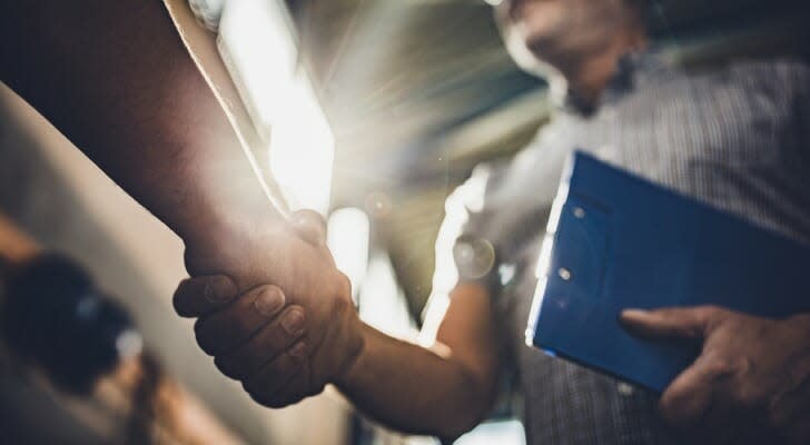 A trustee shakes hands with a client