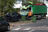 The scene of a collision in Broad Walk, Kidbrooke, south-east London, where the driver of a lorry which hit two cars before crashing into a house has died and an 11-year-old child is in a life-threatening condition in hospital.