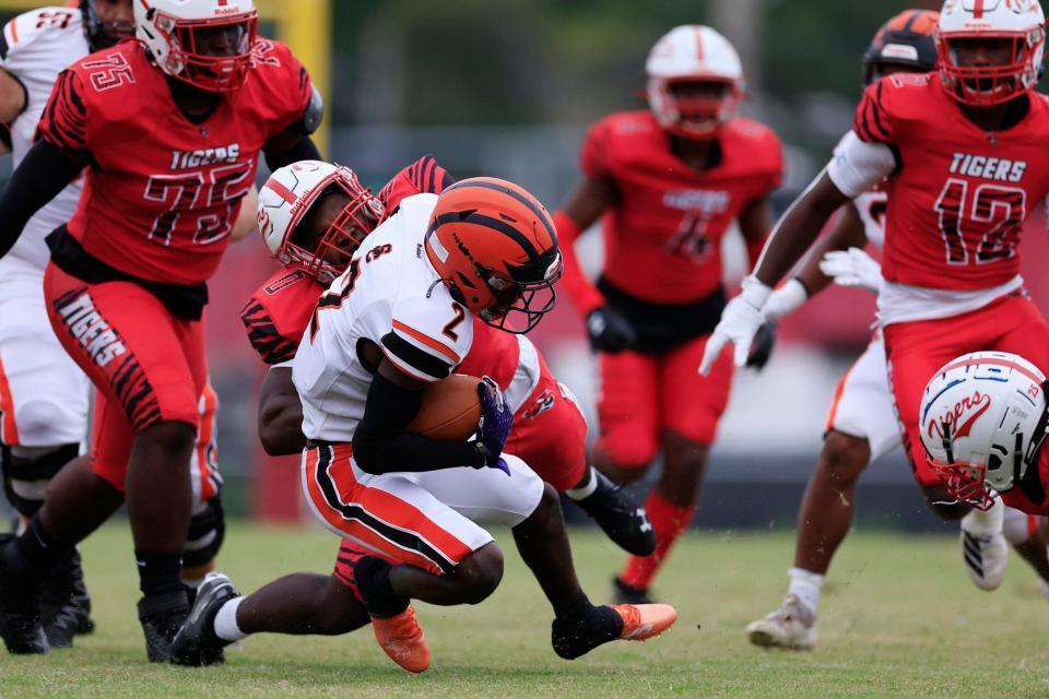 Andrew Jackson's Grayson Howard (0) tackles Spruce Creek's Tony Kinsler (2) during the first quarter of a regular season football game Friday, Sept. 18, 2022 at Andrew Jackson High School football stadium in Jacksonville. The Andrew Jackson Tigers defeated the Spruce Creek Hawks 35-6.