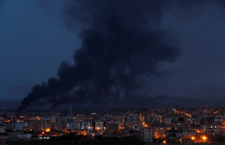 Smoke rises over the Syrian town of Ras al Ain, as seen from the Turkish border town of Ceylanpinar