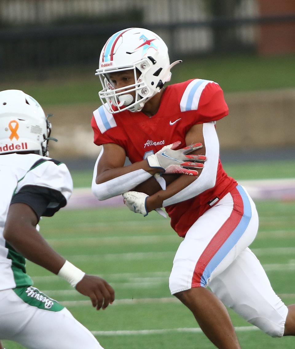 Alliance's Ex'Ziriaun Williamson carries the ball during their game against Bedford at Kehres Stadium, Friday, September 2, 2022.