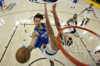 Orlando Magic guard Cole Anthony shoots while defended by Minnesota Timberwolves center Rudy Gobert during the first half of an NBA basketball game, Friday, Feb. 3, 2023, in Minneapolis. (AP Photo/Abbie Parr)