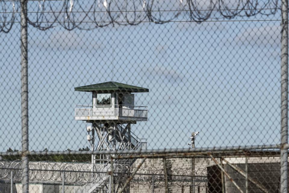 FILE - A guard tower stands above the Lee Correctional Institution, a maximum security prison in Bishopville, S.C. A South Carolina prison policy banning inmates from speaking to reporters in person or having their writings directly published violates the First Amendment free speech rights of prisoners, a civil rights organization said in a federal lawsuit Thursday, Feb. 22, 2024. (AP Photo/Sean Rayford, File)