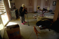 Ikhlas Helmy, an 88-year-old owner of a houseboat in Cairo, Egypt, stands in her now empty living room on June 27, 2022. A government push to remove the string of houseboats from Cairo’s Nile banks has dwindled their numbers from a several dozen to just a handful. Helmy stands to evicted, and the boat moved or demolished. The tradition of living on the Nile River dates back to the 1800s, and the removal of the boats has drawn criticism in Egypt. The government says it plans to develop the waterfront. (AP Photo/Tarek Wagih)