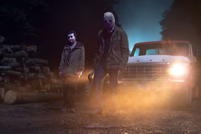 <p>John Armour/Lionsgate</p> The titular masked murderers return in 'The Strangers: Chapter 1'