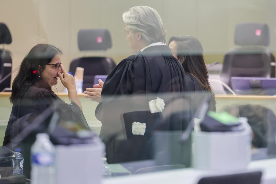 Lawyers Delphine Paci, left, and Michel Bouchat, center, speak with each other at the start of the Brussels terrorist attack trial verdict in the Justitia building in Brussels, Tuesday, July 25, 2023. A jury is expected to render its verdict Tuesday over Belgium's deadliest peacetime attack. The suicide bombings at the Brussels airport and a busy subway station in 2016 killed 32 people in a wave of attacks in Europe claimed by the Islamic State group. (Olivier Matthys, Pool Photo via AP)
