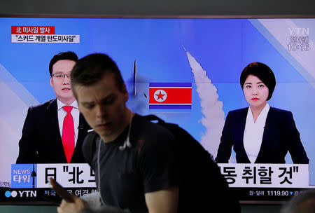 People watch a television broadcasting a news report on North Korea firing what appeared to be a short-range ballistic missile, at a railway station in Seoul, South Korea, May 29, 2017. REUTERS/Kim Hong-Ji