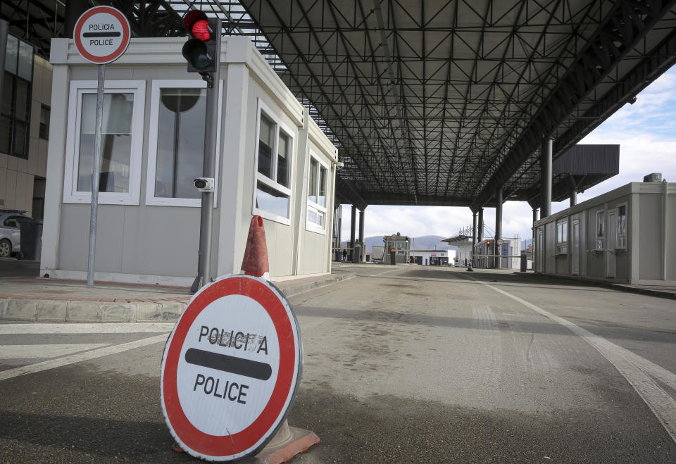 A police sign is seen at the closed Merdare border crossing between Kosovo and Serbia on Wednesday, Dec. 28, 2022. Kosovo closed the border crossing in Merdare, following an erected barricade by Serb protesters inside Serbia late Tuesday night, the third official border crossing closed this month following rising tensions between Kosovo and Serbia. (AP Photo/Visar Kryeziu)