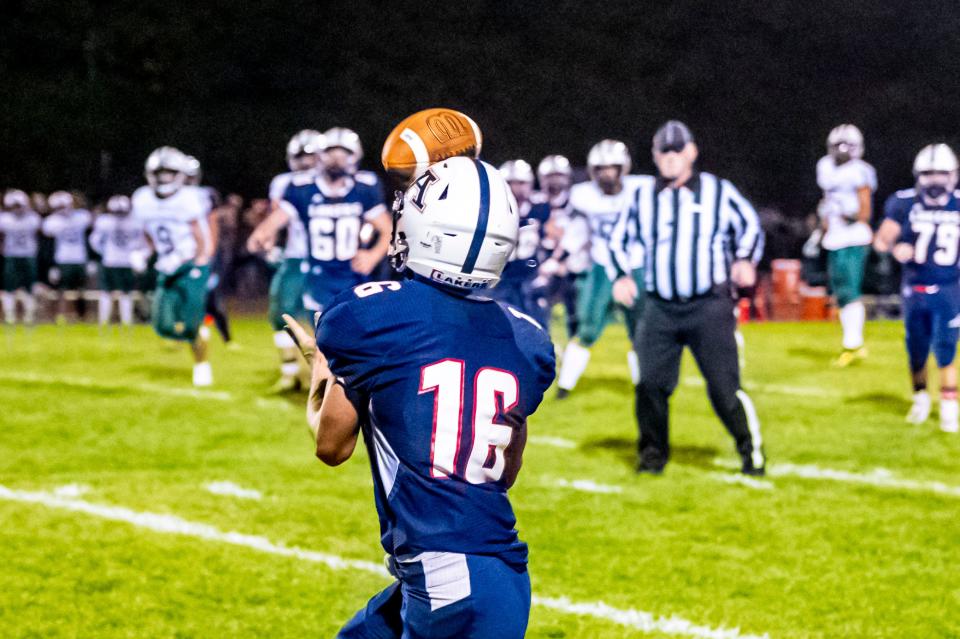 Apponequet's Harrison Lemieux makes the reception along the sidelines.