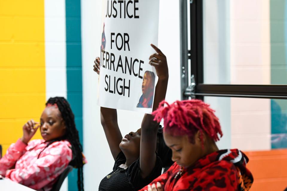 A'niylah Sligh, 10, center, holds a sign for her father, Terrance Sligh, who was killed in a deputy-involved shooting, during a press conference at Jud Hub Social Innovation Center in Greenville on Monday, October 3, 2022.