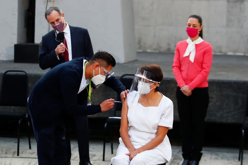 Maria Irene Ramirez receives the first injection with a dose of the Pfizer/BioNtech COVID-19 vaccine at General Hospital, in Mexico City