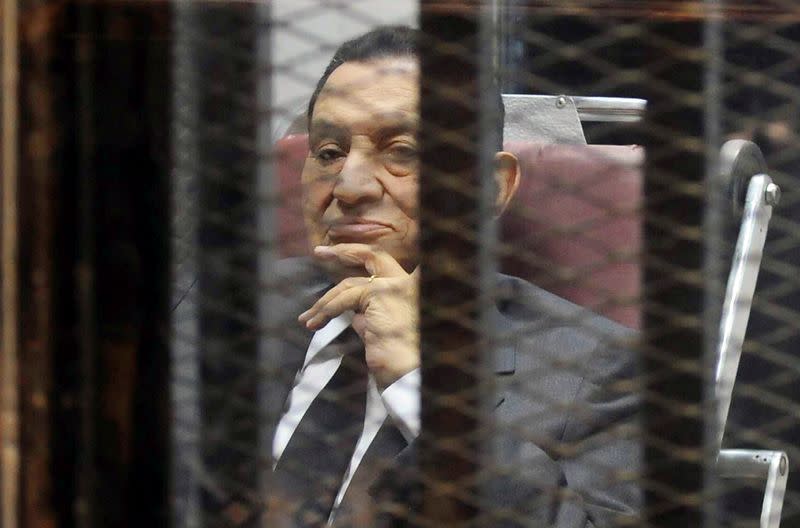 FILE PHOTO: Egypt's ousted President Hosni Mubarak looks on as he reacts inside a dock at the police academy on the outskirts of Cairo