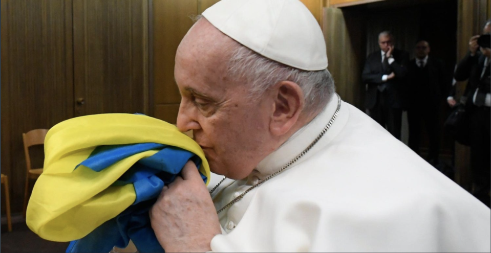 Pope Francis holds a Ukrainian flag after a screening at the Vatican of the documentary 'Freedom on Fire'