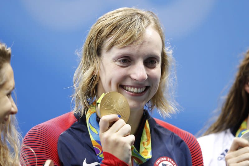 Katie Ledecky shows off a gold medal for her record time of 8:04.79 in the Women's 800M Freestyle final in the Olympic Aquatics Stadium at the 2016 Rio Summer Olympics in Rio de Janeiro on August 12, 2016. File Photo by Matthew Healey/UPI